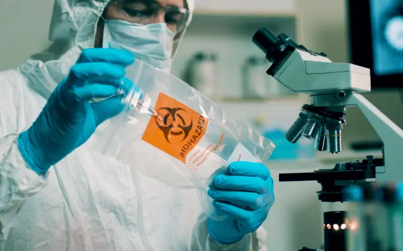 A lab scientist holding a biohazard sample