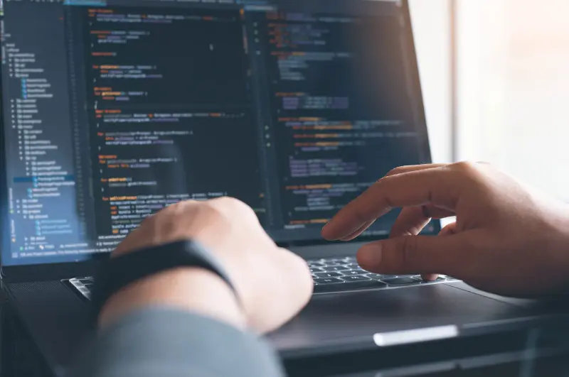 Hands at a code editor