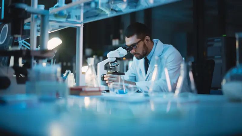 A scientist at a microscope
